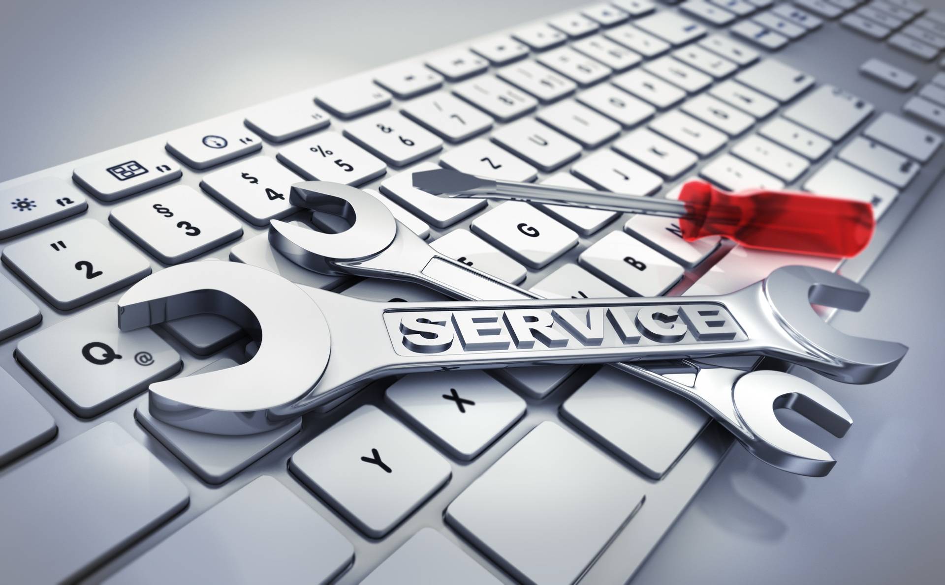 Schraubenschluessel und Schraubendreher auf Tastatur als Servicemotiv | Notdienst für Heizöl